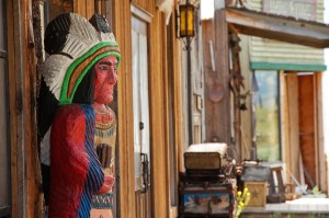 Cigar store sculpture in front of saloon 